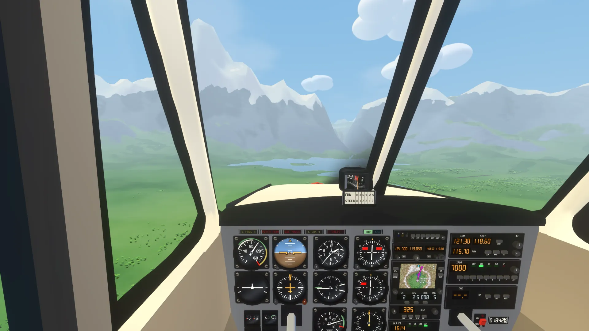 View from the cockpit over the instrument panel towards a lake and mountains